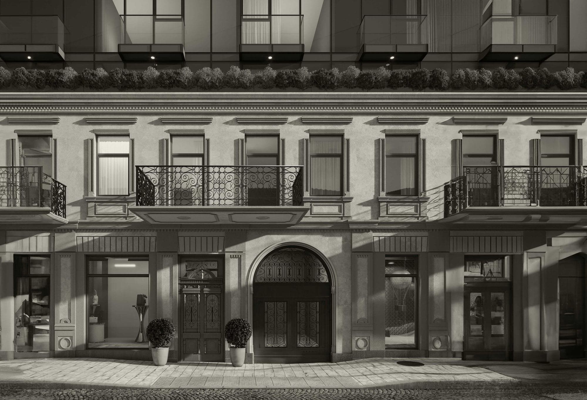 La façade de 1888 de Next Downtown en noir et blanc : balcons en ferronnerie, arcades et vitrines du rez-de-chaussée